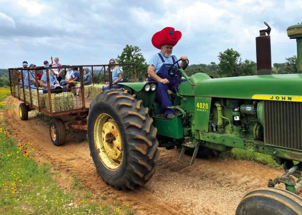 Here is one of the many volunteers at Gospel Rocks Ranch giving the kids a tractor hayride. Courtesy of Jon Hager