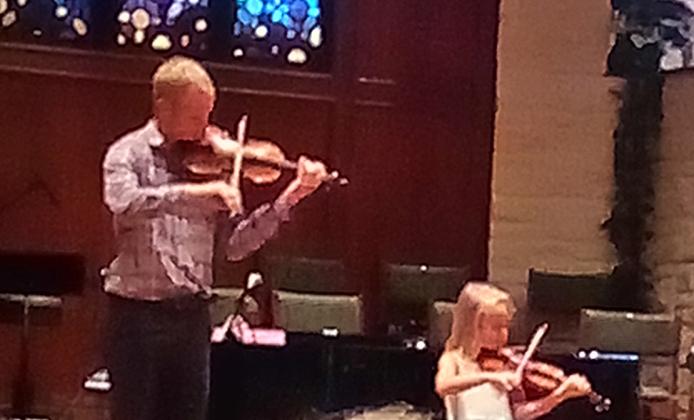 Jonathan and Zoe playing their violins at Zoe's last recital. Courtesy of Katherine Hager