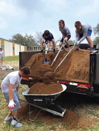 Bentley Watson, Jax Williams, Rein Hooten, and Caden White helping with the garden project Courtesy of Shannon Padgett