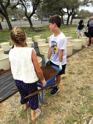 Kyson Shanklin and Mandi Fry helping with the garden project Courtesy of Shannon Padgett