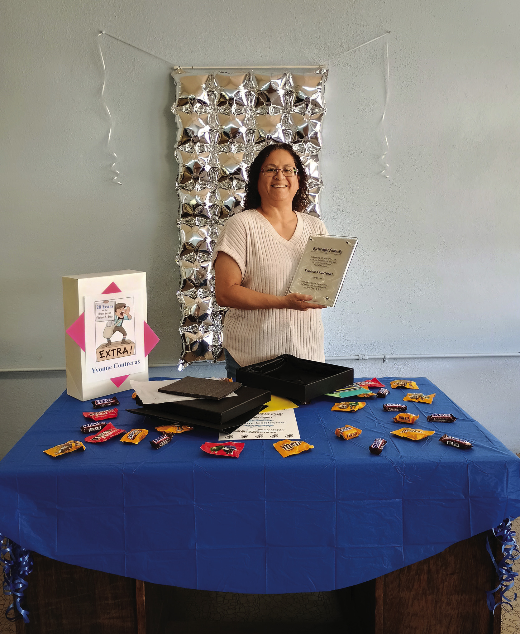 Yvonne is standing at this decorated desk in our front lobby sprinkled with chocolate and peanut candy. Yvonne loves peanuts! She is holding her newly opened glass plaque of appreciation which is on display at the news office. Photo by Djuana Payton
