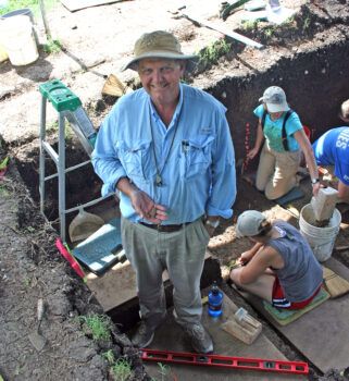 Archaeologist Dr. Michael Waters holding a 15,500-year-old spear point, one of the oldest ever found in North America. Courtesy of Michael Waters