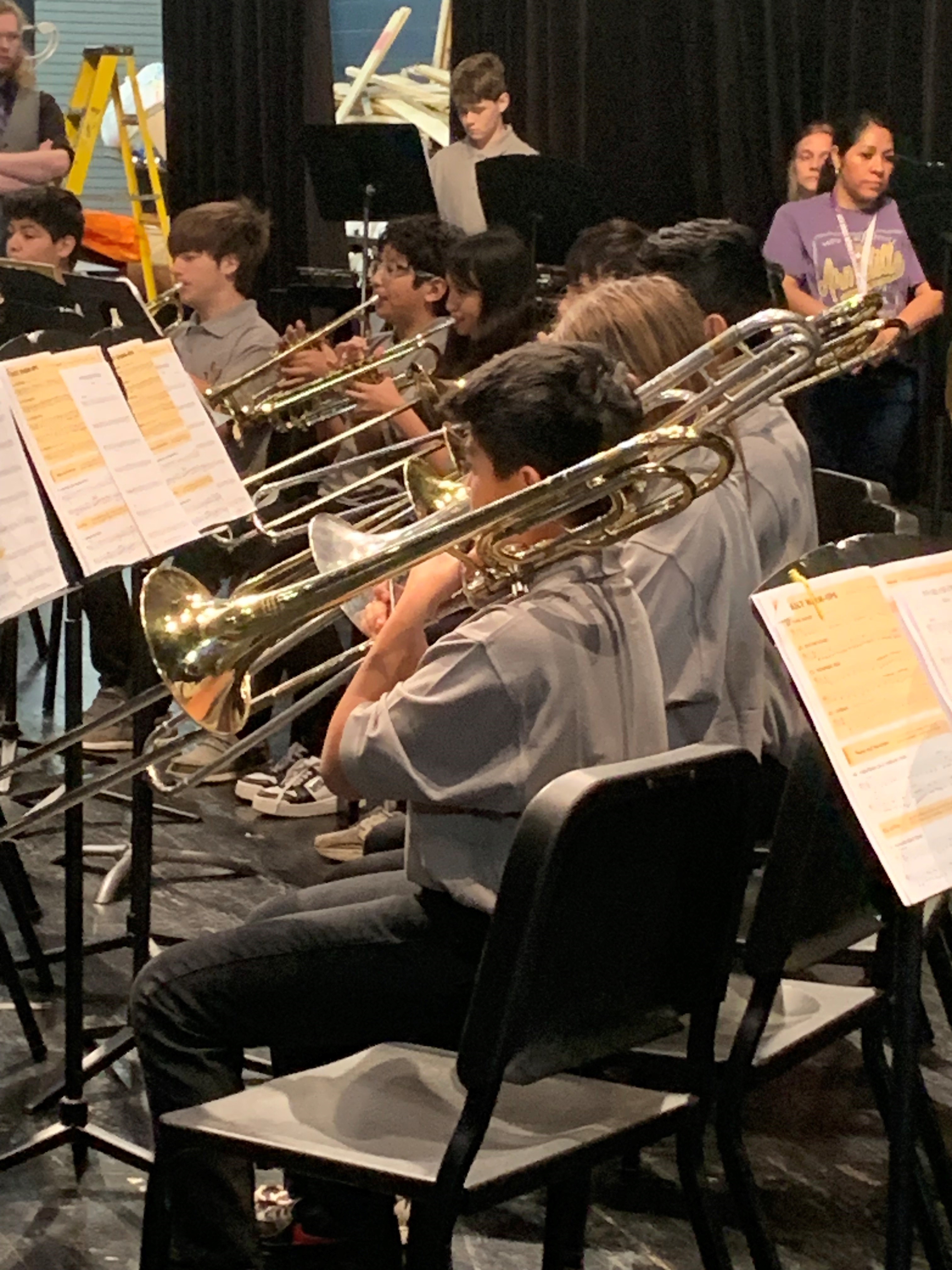 Debin Rodriguez and the brass section during their warm-up.