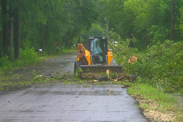 Residents in Huntsville clear downed trees left in the wake of Hurricane Beryl. Michael Miller/Texas A&M AgriLife Marketing and Communications