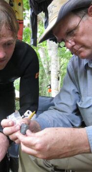 Waters and then-student Morgan Smith ’19 examining a 14,600-year-old knife minutes after it was found during a dig. Courtesy of Michael Waters