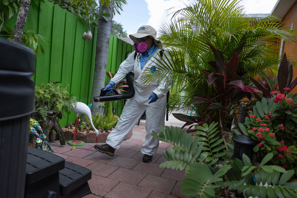 A Miami-Dade mosquito control inspector sprays a pesticide to kill adult mosquitos on June 29, 2023 in Miami, Florida, after four people in Sarasota County, Florida, and one in Cameron County, Texas, reported cases of malaria. Credit: Joe Raedle/Getty Images