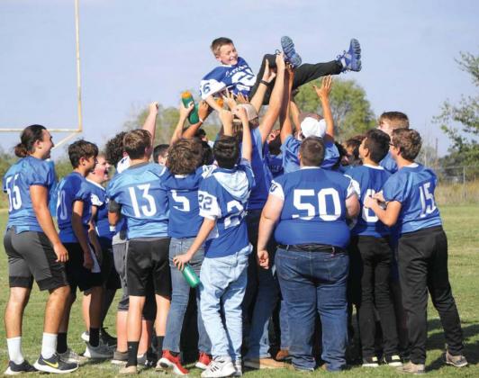Cherokee Jr High’s Weston Woolsey is hoisted up by his teammates. The Jr High Indians defeated their county rival Richland Springs Coyotes 21-20.