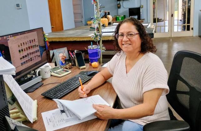 Our Advertising Director Yvonne Contreras at work - creating your ads! Photo by Djuana Payton
