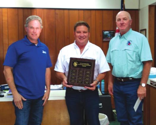 Michael Wadsworth, Code Enforcement Officer, displays a Supervisor of the Quarter plaque with his name engraved for selection as the City's Supervisor of the Quarter, 3rd Quarter of the year. He also received a gift certificate to a local restaurant. At Michael's right is Alderman Marcus Amthor and to his left is City Manager Scott Edmonson, both taking part in the formal presentation. Staff Photo)