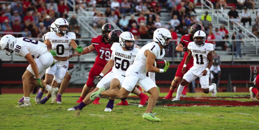 #1 Luke Tharp scoops up a lose ball running it back for a defensive touchdown - he had 15 carries, 104 yards rushing, and a touchdown on the night. Courtesy of Kayti Lackey