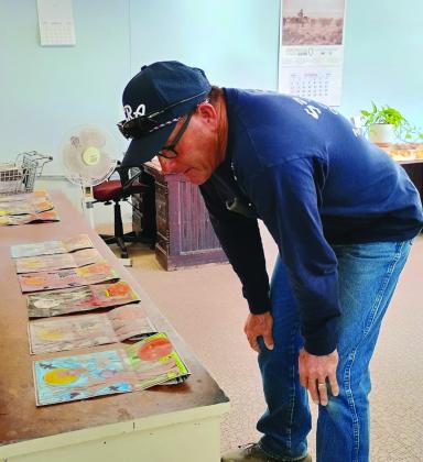 San Saba City Public Works Director Scott Glaze, who was our 2026 Halloween Coloring Page Judge, looked closely at each color page last Friday. - See the winners on the Front Page!