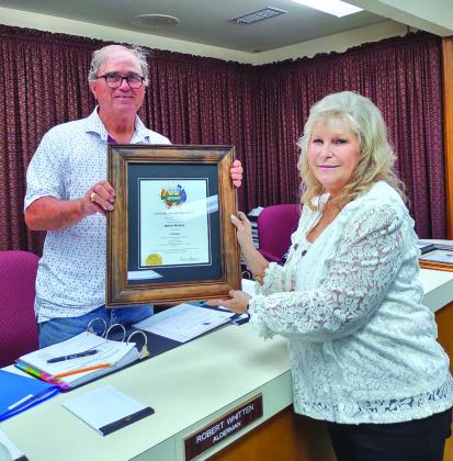 Judge Sharon Blossman presents the Certificate of Election to Alderman Robert Whitten after the swearing in ceremony.