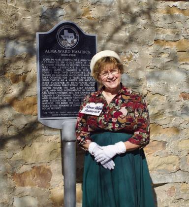 Club President Debbie Shahan asAlma Ward Hamrick, standing next to the State of Texas Historical Marker honoring former SSGC President Hamrick