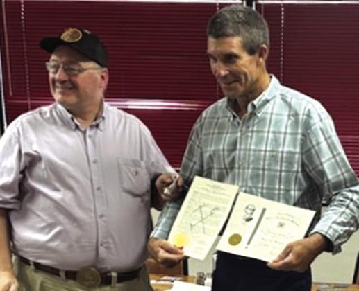 PHOTOGRAPH: Roger D. Hamrick (right} is presented with a distinguished SCV Bronze Cross by Commander Michael Oliver. The Bronze Cross and accompanying proclamation stand as lasting testimony of the camp’s gratitude and esteem for Compatriot Hamrick’s meritorious service.