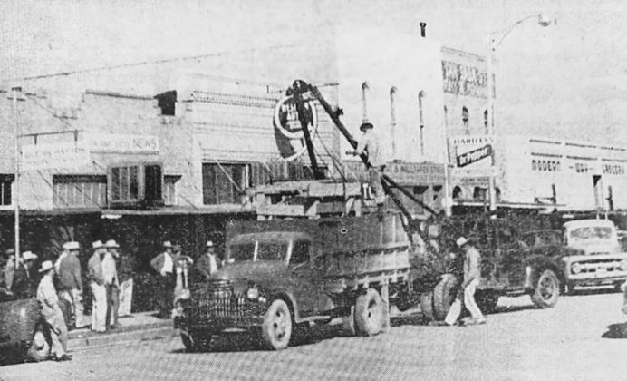 MARCH 25, 1954 - NEW PRESS UNLOADED–A new Kluge automatic job press is shown here being unloaded for the San Saba News. The new press, the first automatic press in San Saba county, has been set up by a factory representative and now is in commercial operation. Some years ago The News installed an open press with a Miller automatic feed attachment, but it was found that this equipment did not fill the firm's need. The News is open to visitors at all times; however it is preferred that visits be made during t