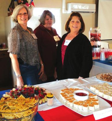 SSGC hostesses for March readily and happily pose prior to the start of the meeting.