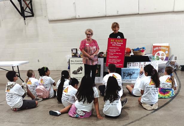 The woman on the left speaking to the fifth graders is Jill Pilcher, VP for Beef Education. The woman on the right holding the sign is Betsy Rafferty.