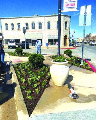 Buddy Whitley watering beds after the ladies had planted about 500 plants.
