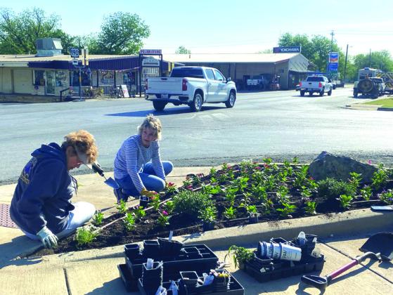 Kathleen and Debbie also planting flowers. (Not pictured is Cissy Williams)