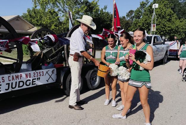 Ross Cox, Sr. is seen here passing out candy treats to some Burnet High School cheerleaders. Photo by Cheryl Ayers