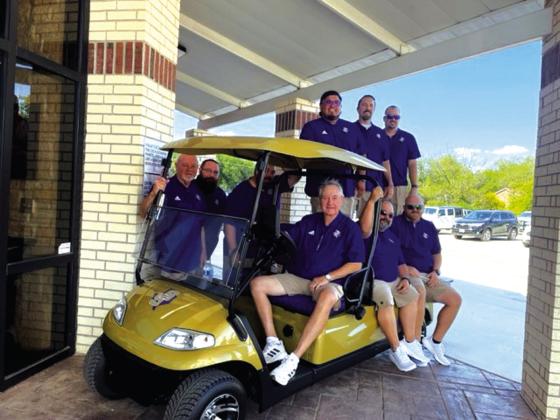 San Saba ISD coaching staff pose with their new utility golf cart presented to them at the Meet the Dillos event Friday night. Photo by Jake Lackey