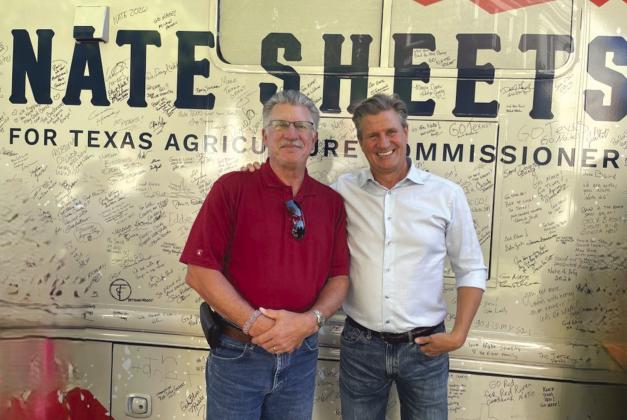 Folks along the campaign trail are invited to sign Nate Sheets’ bus. Standing in front of the buss are Jeffrey Carlson (L) and Nate Sheets (R). Courtesy of Jeffrey Carlson