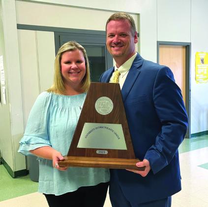 Band Directors Chans and Misty Moellendorf proudly holding the Sweepstakes trophy