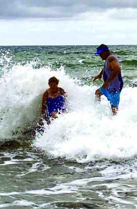 Sue Ransom hit by the wave while her son laughs! Great fun!