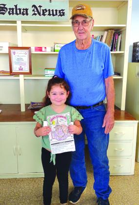 Coloring Contest 3-5 winner Kailynn Cisneroz proudly displaying her first place winning coloring page. Kailynn is pictured here with her grandpa, Elmo Davis.