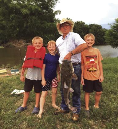 Don Fowler and grandchildren Luke, Mason, and Grant Fowler caught this 20-pound catfish on the San Saba River using jumbo grasshoppers. Submitted by Barbara Fowler