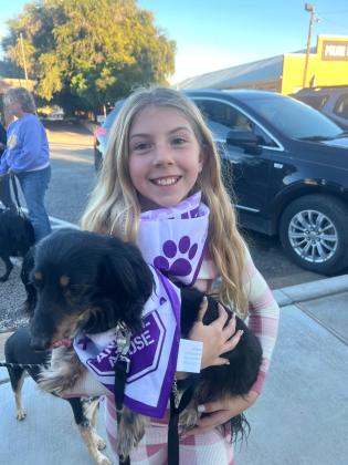 Young participant and puppy in parade
