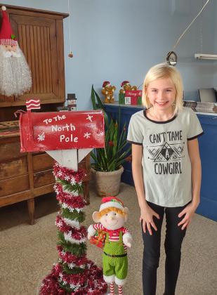 Ruby McGee posing with the elf by Santa's Mailbox!