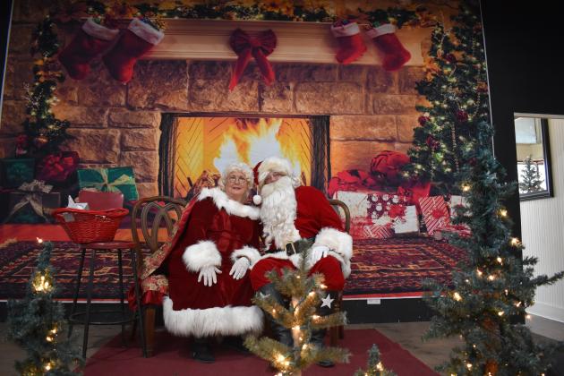 Santa &amp; Mrs. Claus keeping warm by the fire