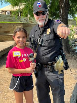 Fishing with local law enforcement during Kids' Nature Kamp