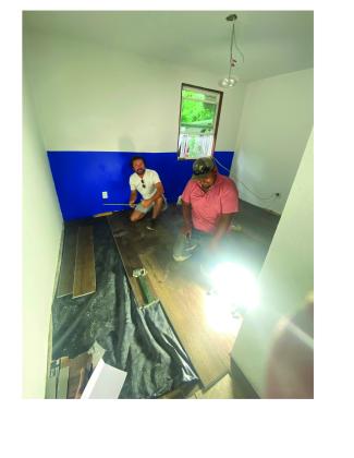 Cade and Mondo installing flooring