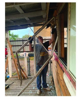 Jessica Eudy removing a window