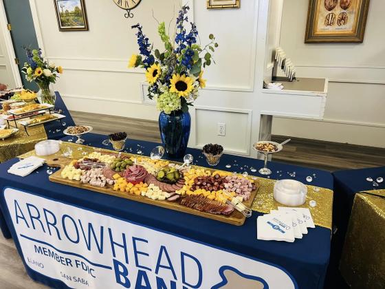 Large charcuterie, of meats and cheese with olives and pickles from Miller Meat Market in Llano and a beautiful flower arrangement from Fancy Flowers.