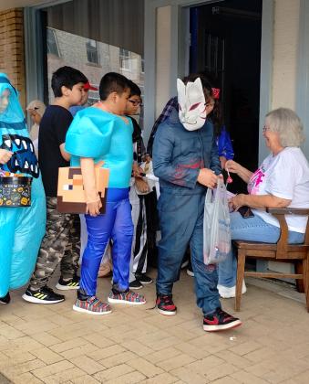 Carolyn Boswell Preece at the News Office having a great time handing out candy.