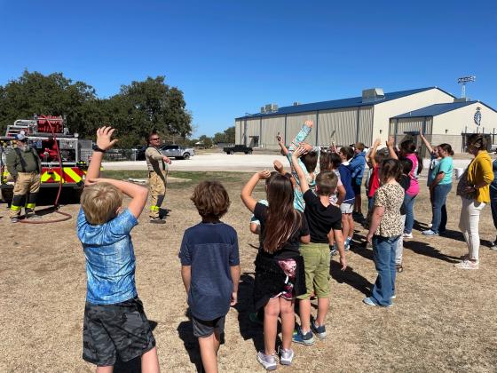 Will Cade educates Cherokee ISD students as Cherokee VFD Chief Wade Brooks looks on.