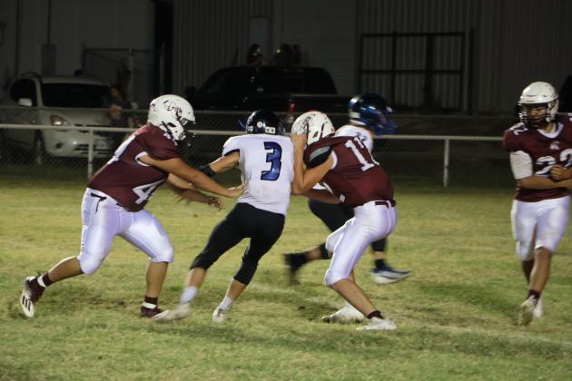 #3 Rush Norris fights off two Lohn Eagles in last Thursday's game - Courtesy of Pam Starr, RSISD