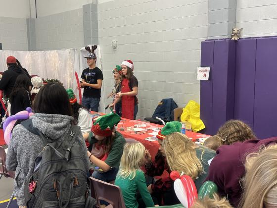 SSHS Art and NHS students providing balloon art and face painting to SSES students.