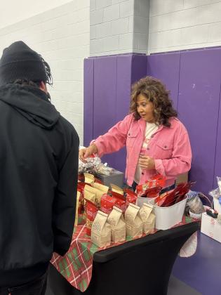 Rosemary Cisneroz, SSES employee, helping a customer parent with some Alamo Pecan goodies.