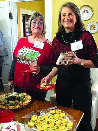 Janis Murray and Barbara Fowler enjoy the delicious array of sweets and savories prepared by the hostesses.