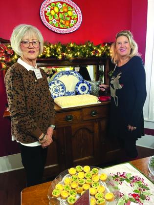 Rhonda Killion and Tracy Farley served a beautifully decorated red velvet cake from Rhonda's antique sideboard.