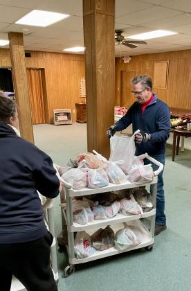 Local pastor Judy Swarts and Coordinator Scott Snyder get bags ready.