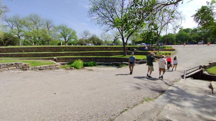Tourists looking at the Waterfall in Mill Pond Park - photo by Yvonne Contreras
