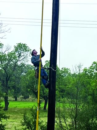 Jake Uptain, City Electric Department crew member, working on the electric lines after the storm
