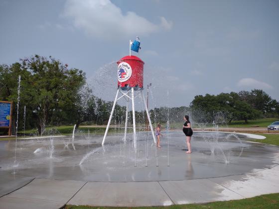 Katelyn and Zavanna McCoury  playing at the Splash Pad