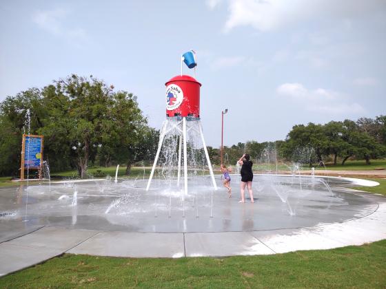 Katelyn and Zavanna McCoury timing it just right to get the water shooting out from the bottom of the tower.