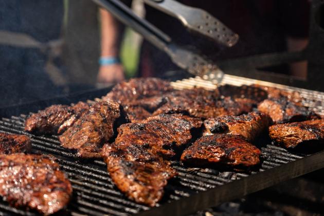 A pitmaster prepares barbecue at Troubadour Festival at Aggie Park on May 18, 2024. Katie Perkins/Texas A&amp;M AgriLife Marketing and Communications